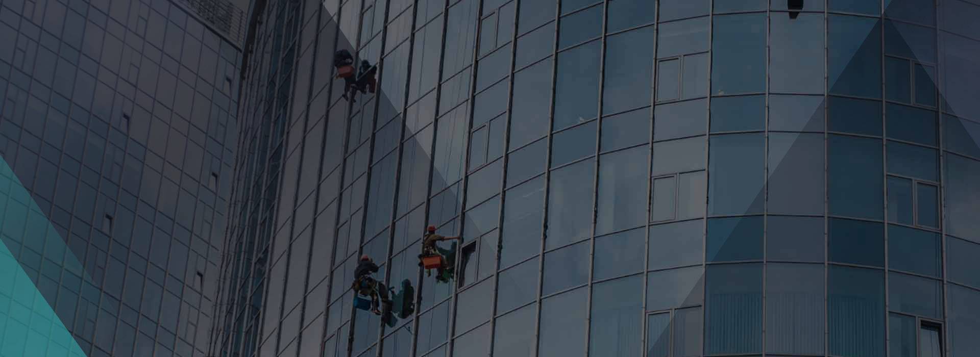 Rope access technicians on a curved glass tower